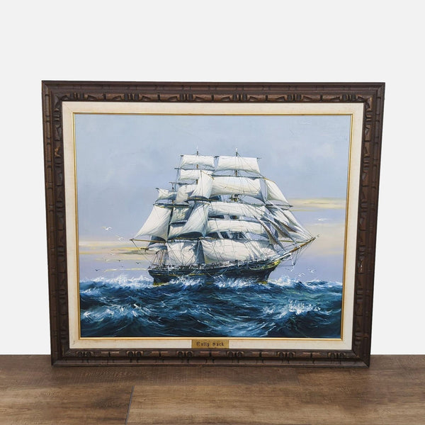 Painting of the Cutty Sark, a British clipper ship from 1869, in an ornate wooden frame.