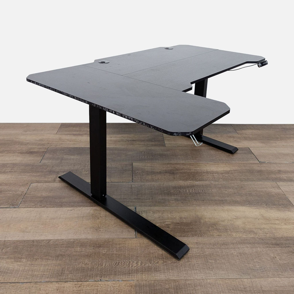 Height-adjustable Reperch desk with sleek black MDF top and metal legs.