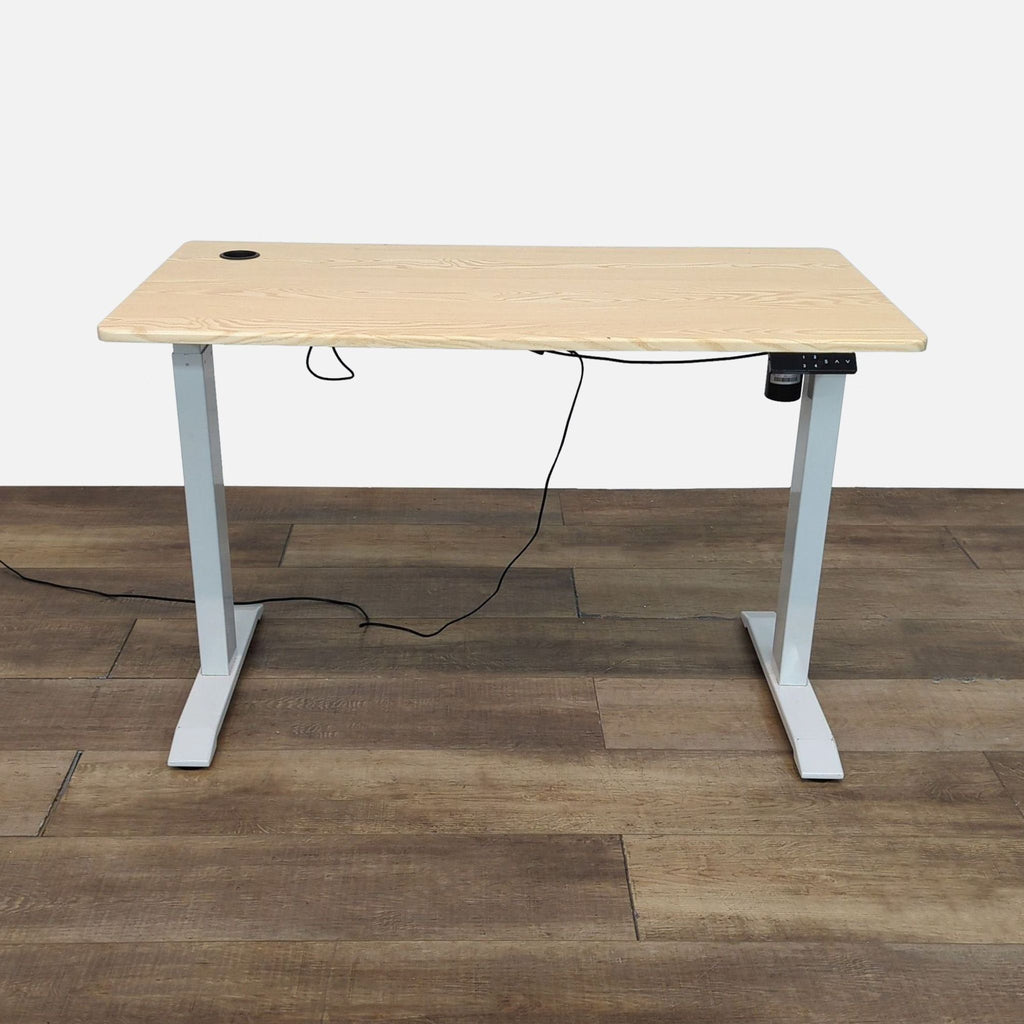 Height-adjustable desk with natural wood finish and 4 programmed settings.