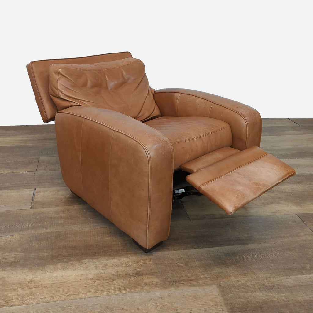 Side view of a Reperch leather recliner with extended footrest on wooden flooring.
