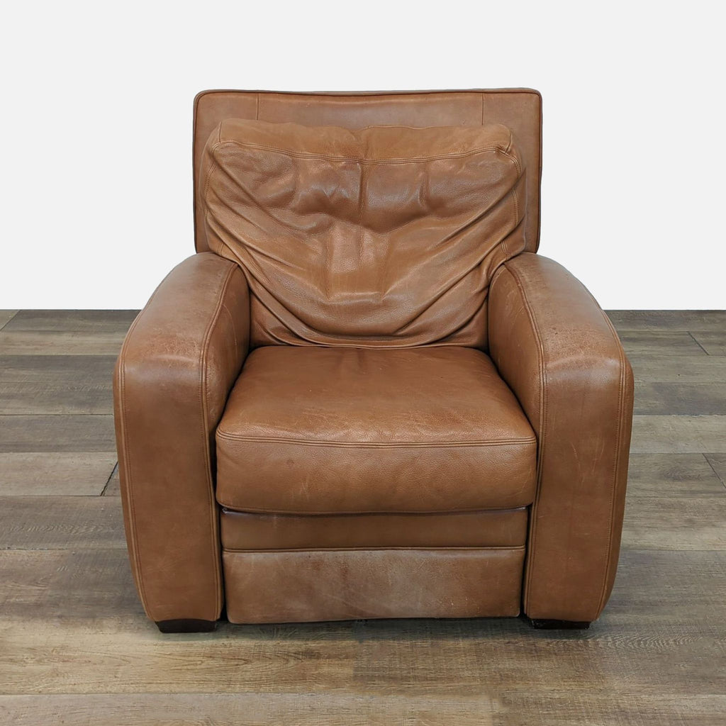 Brown leather recliner from Reperch, front view on a wooden floor.