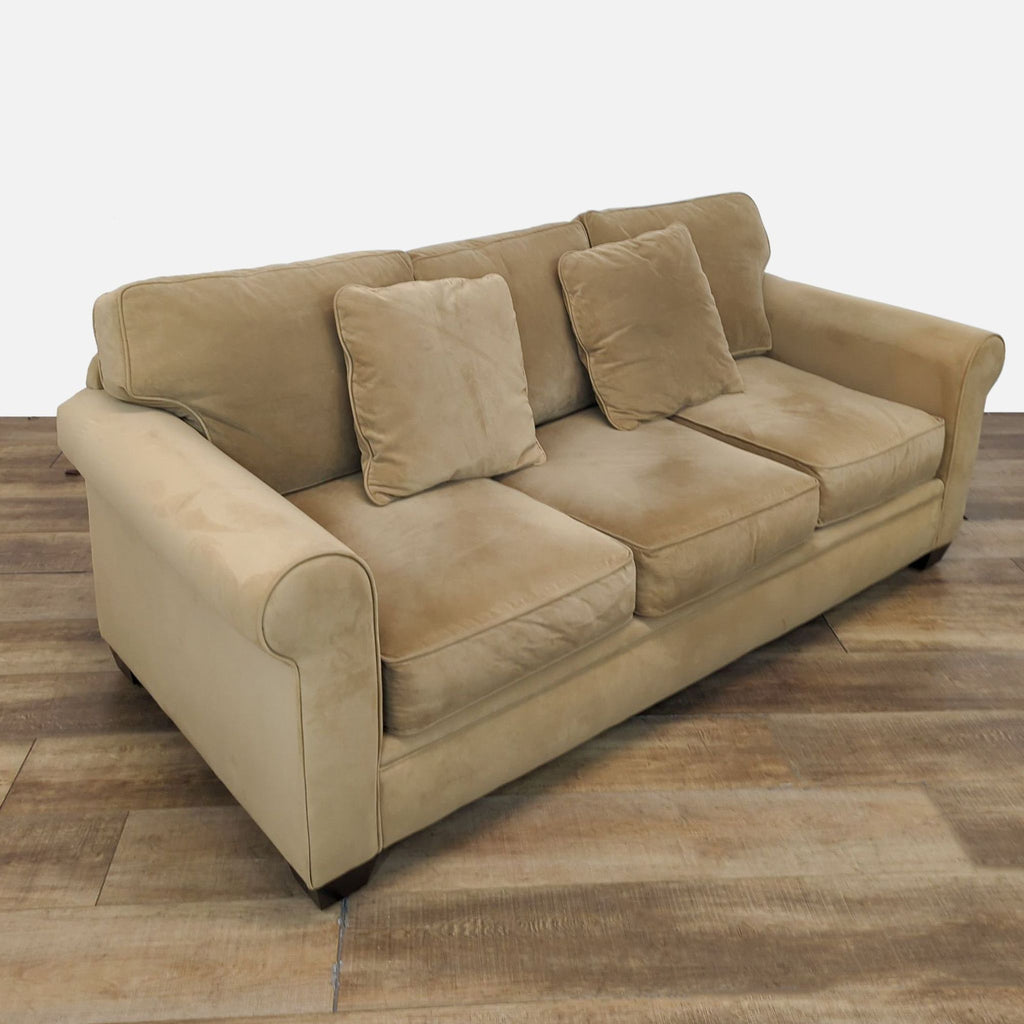 Microfiber sofa with loose cushions and matching pillows, by Reperch.