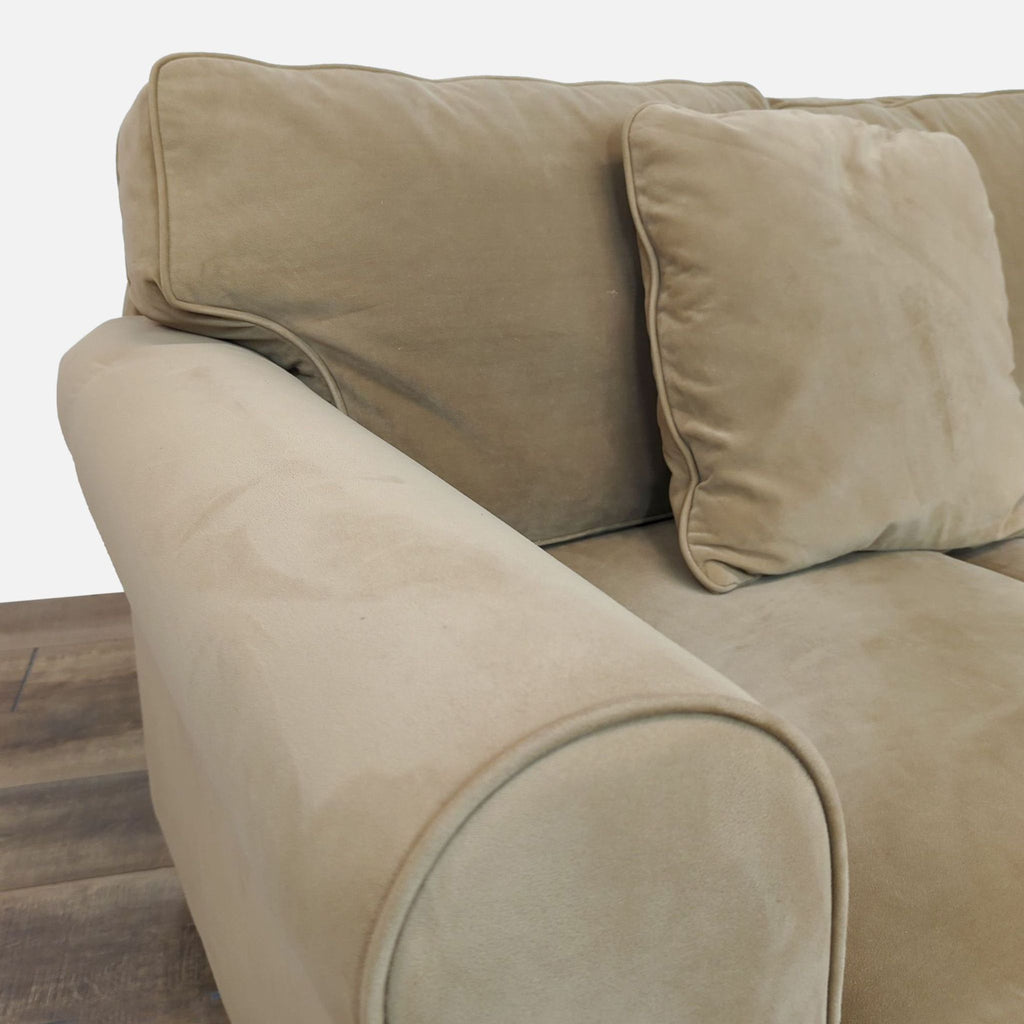 Close-up of rolled arm design on Reperch microfiber sofa.