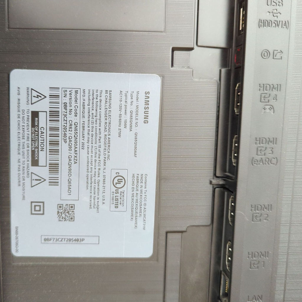 Close-up of Samsung TV ports and specifications on the label.