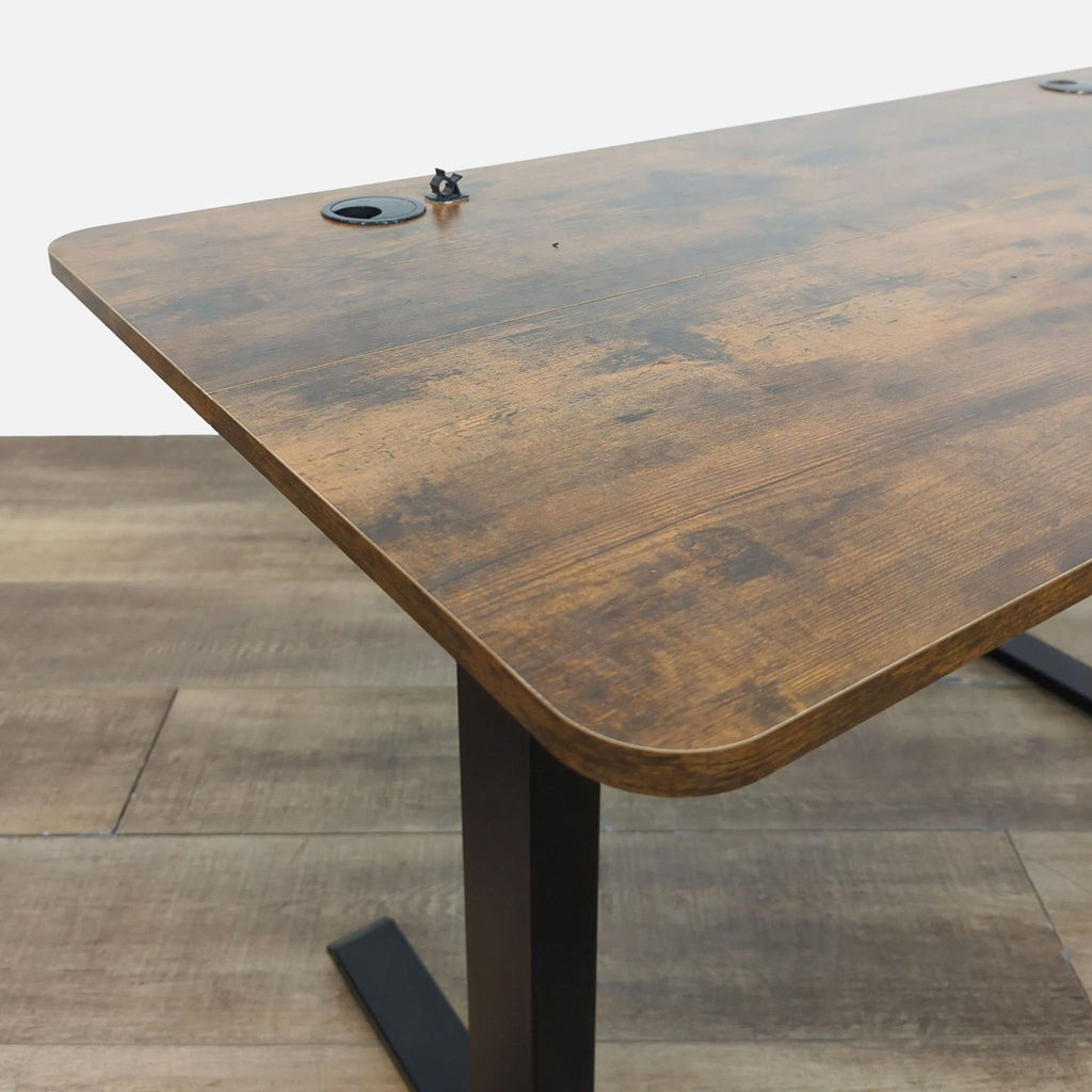 Close-up of the standing desk's rustic wooden top and sturdy frame.  