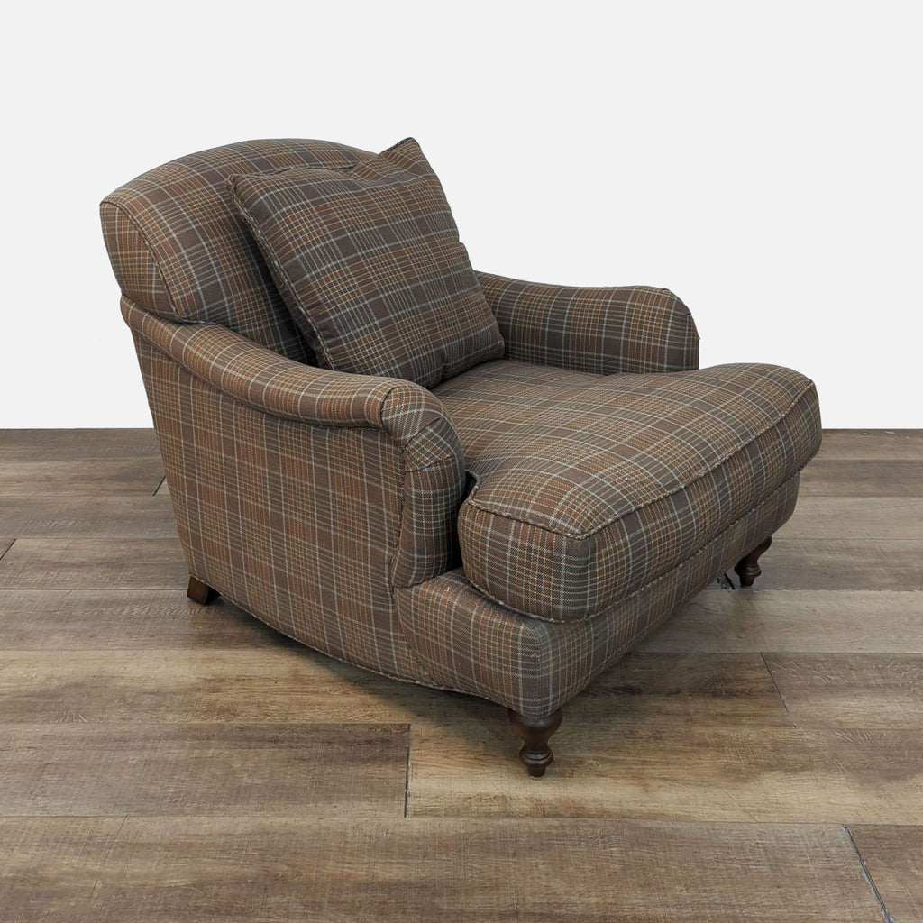 Side view of a plaid lounge chair with classic wooden feet.