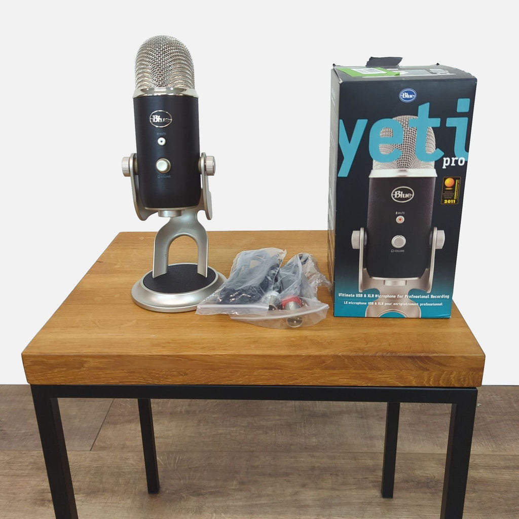 Blue Yeti Pro microphone on a table with box and cables included.