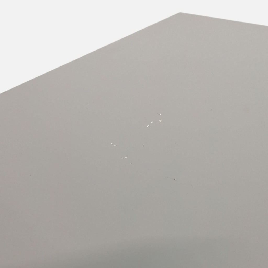 Close-up of white lacquered top on mid-century style credenza with minor marks.