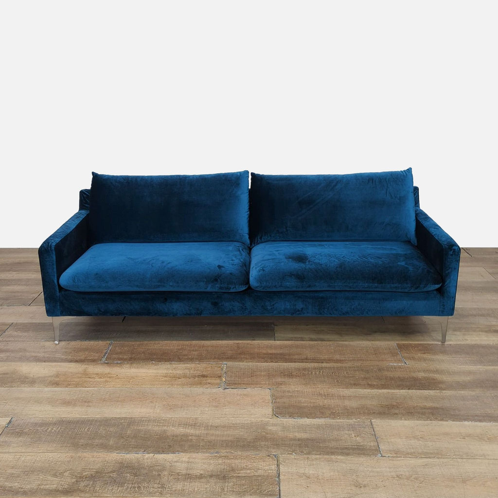 Elegant blue velvet Nuevo 3-seat sofa with silver metal feet.