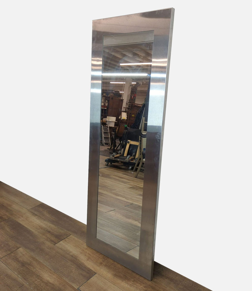 Side angle of a tall mirror with metallic frame, highlighting thickness and design.