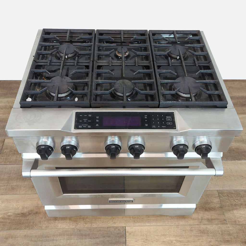 Top view of KitchenAid stainless steel gas range, featuring four burners and control knobs.