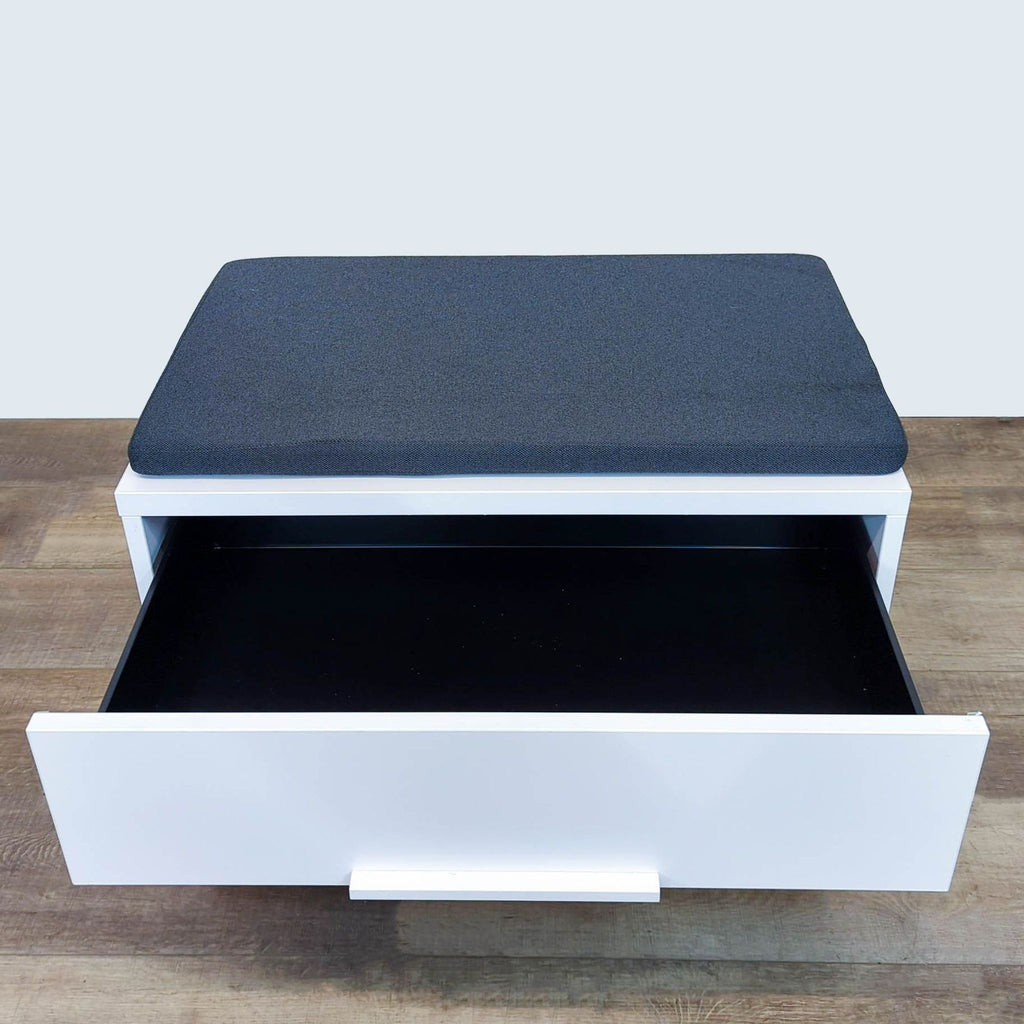 Knoll cabinet with top view, upper drawer open, revealing black interior.