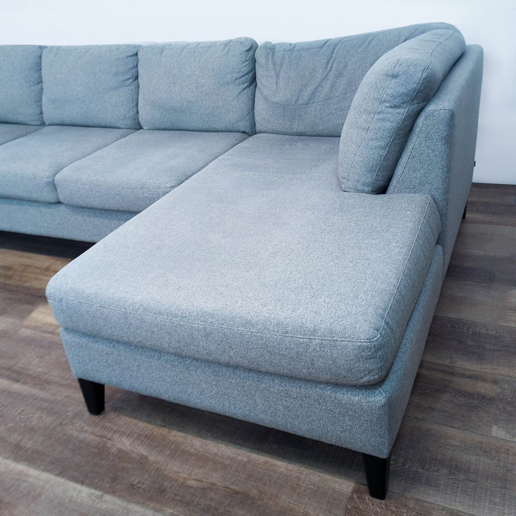 Detail of EQ3 sectional's chaise with fabric upholstery.