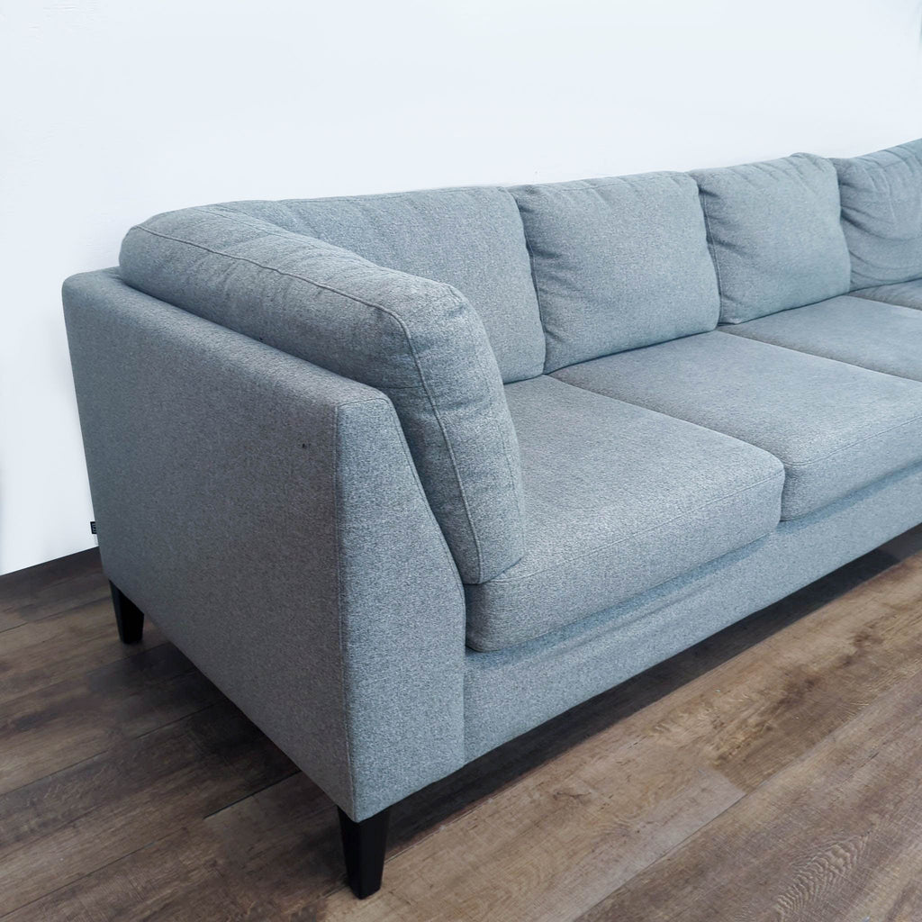 Close-up of an EQ3 sectional’s plush cushions and armrest.