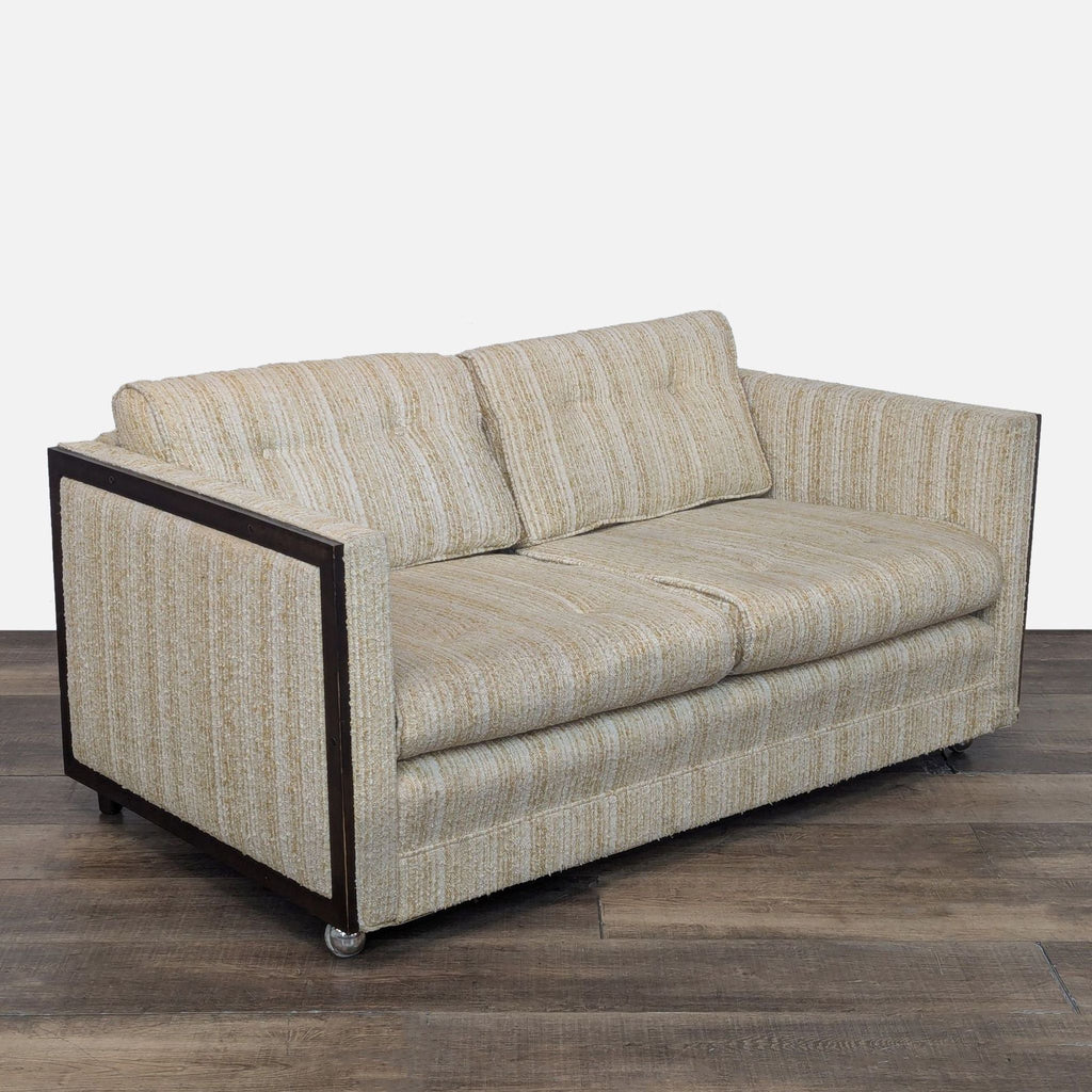 Vintage Connolly loveseat with striped fabric, wood edging, and casters.