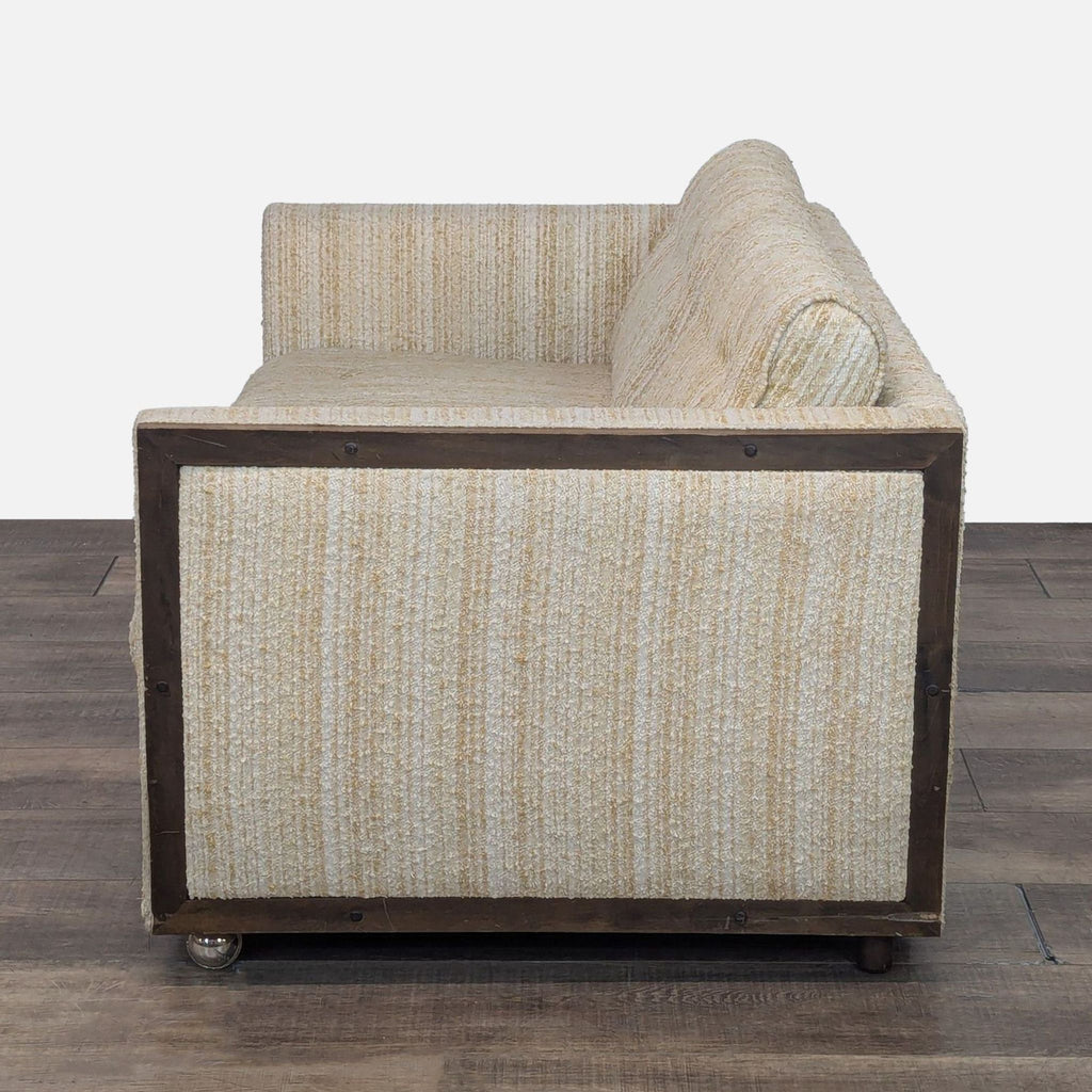 Side view of Connolly loveseat showcasing wood detail and striped upholstery.
