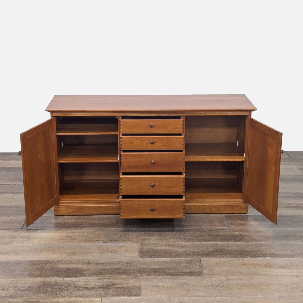 Wooden credenza featuring open cabinets and five spacious drawers, ideal for storage.