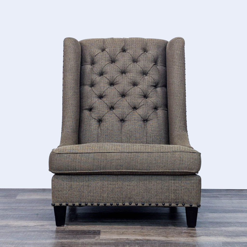 Transitional wingback chair with tufted back and nailhead trim.