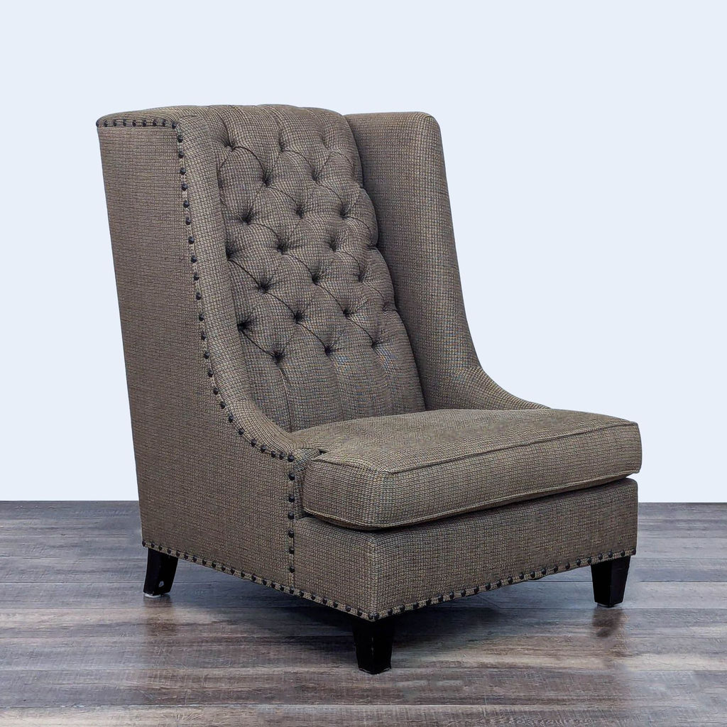 Angled view of tufted wingback chair with decorative trim.