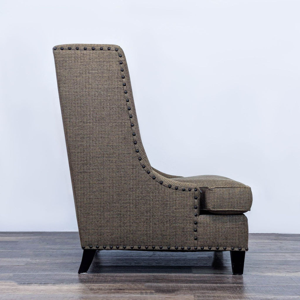 Side view of wingback chair showcasing nailhead detail.
