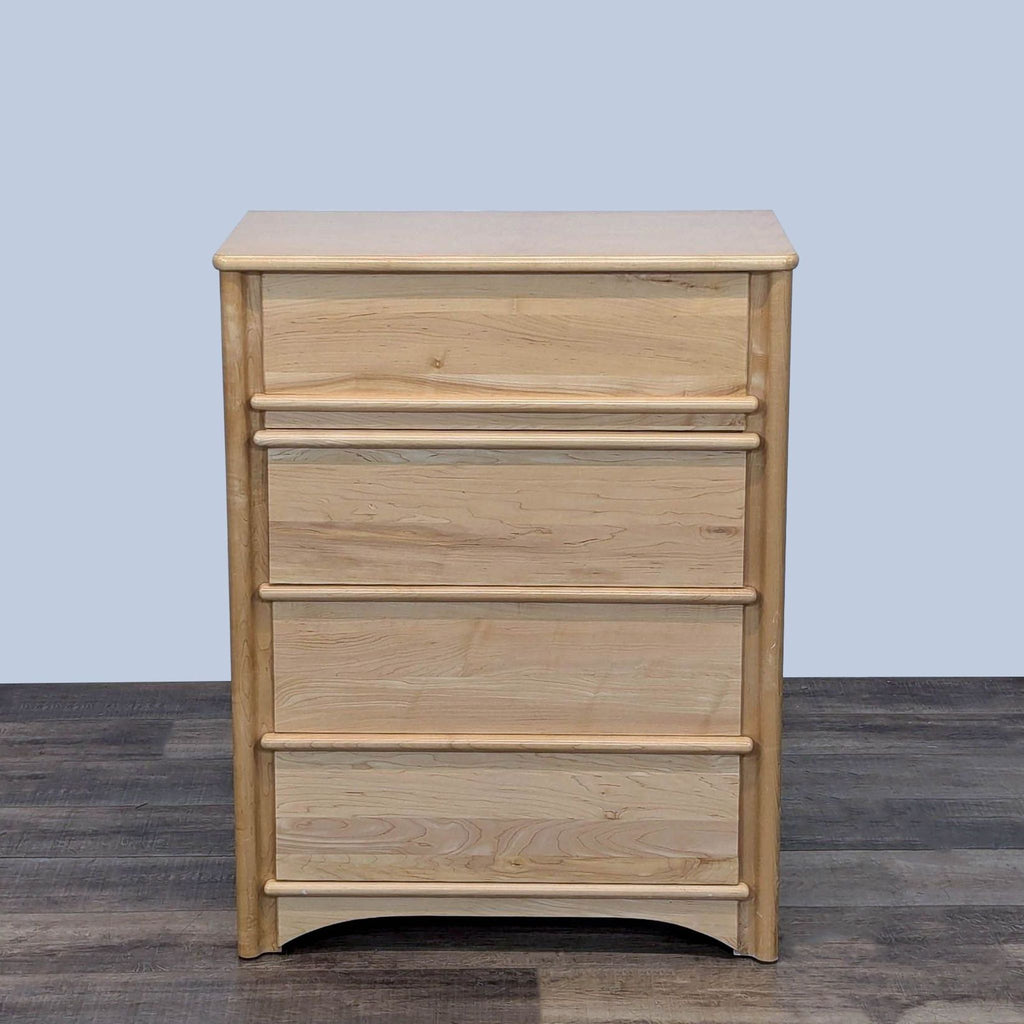 Solid wood dresser with natural finish and four drawers, showing front view.