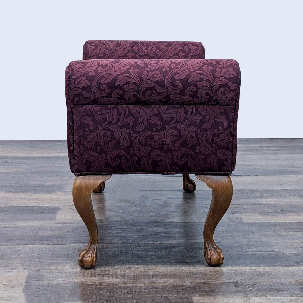 Rear view of a bench featuring detailed cabriole legs and elegant rolled armrests.