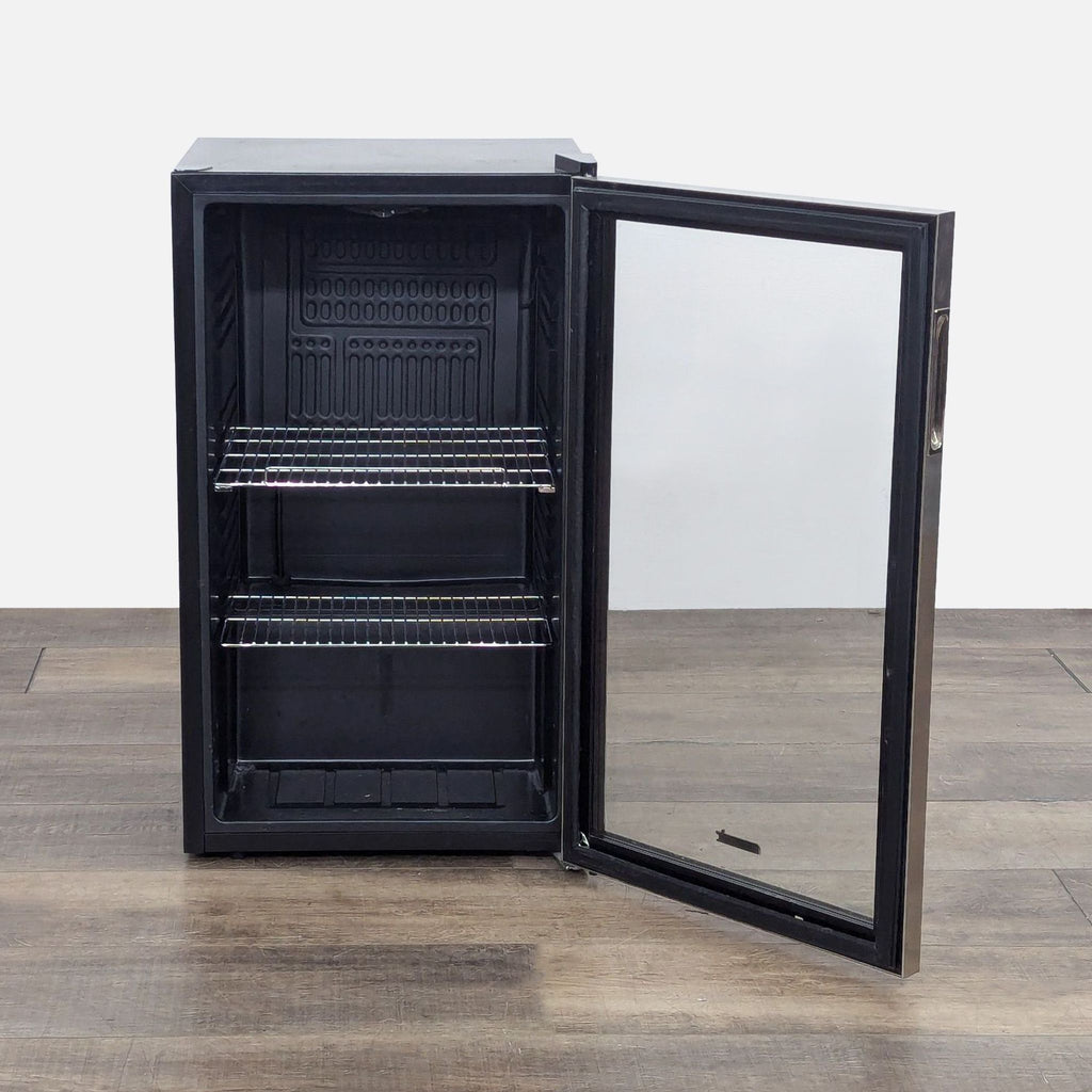 Open NewAir refrigerator displaying interior space with metal shelves.