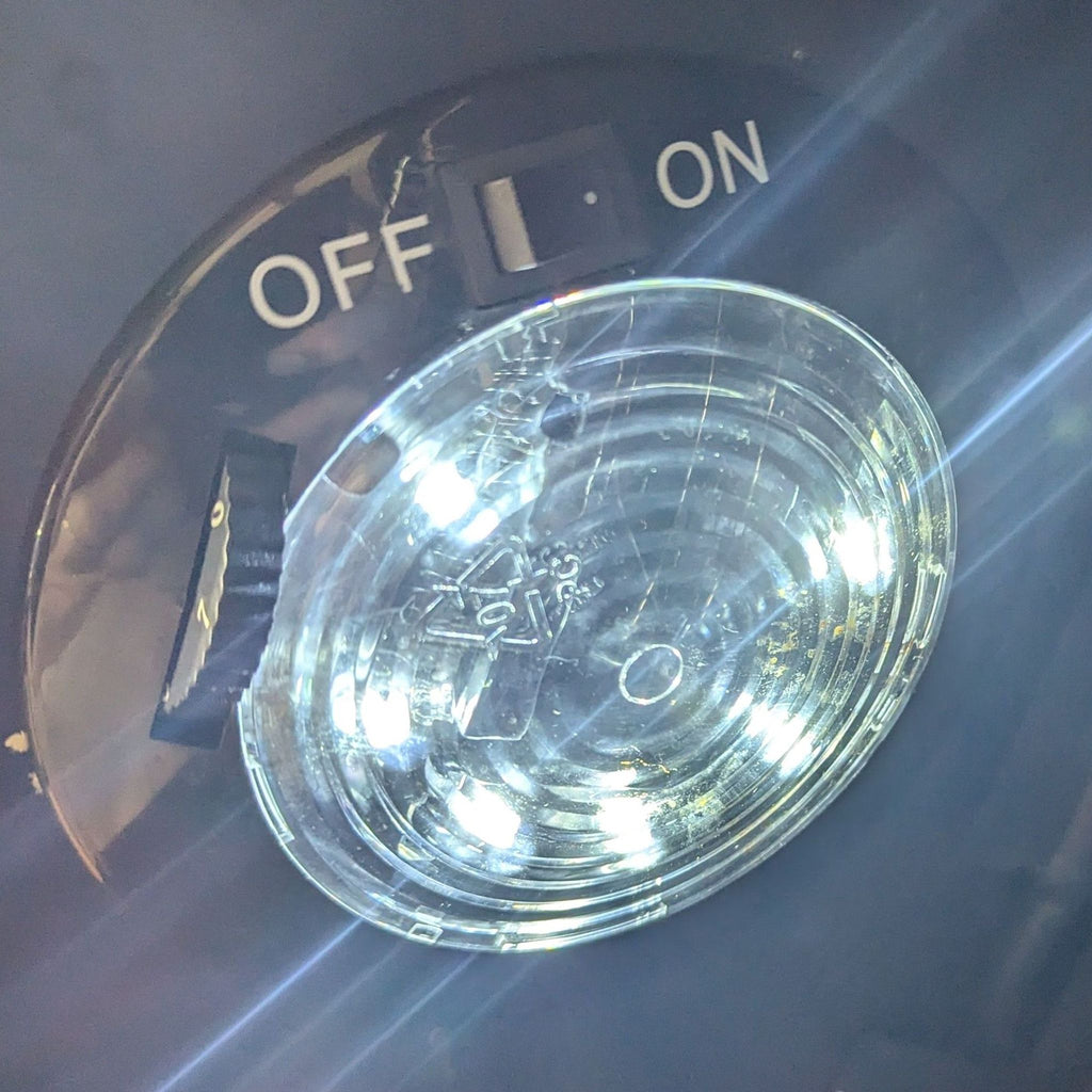 Close-up of the lighting control switch inside the NewAir fridge.