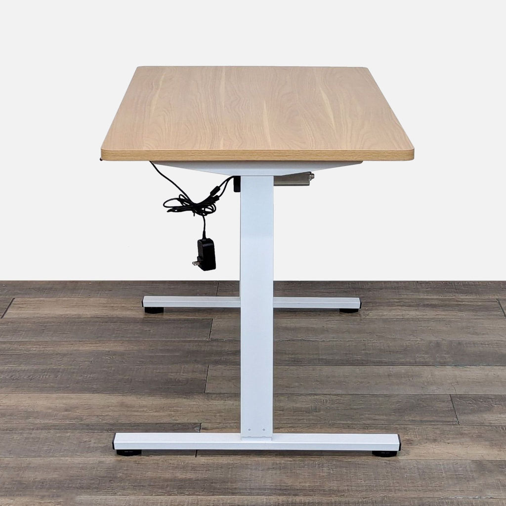 Height-adjustable desk with 4 settings and wood finish.