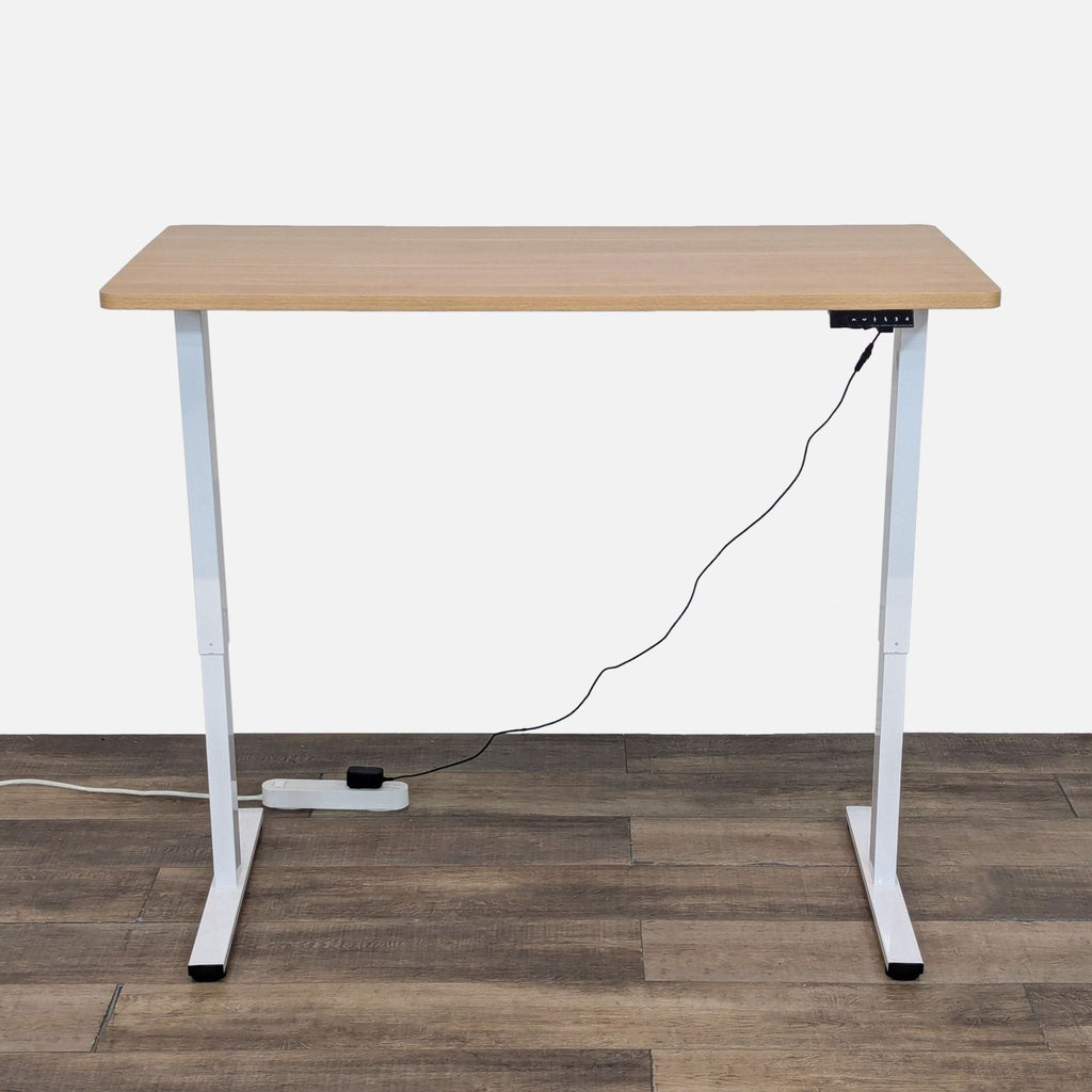 Adjustable desk with wood top and metal frame.