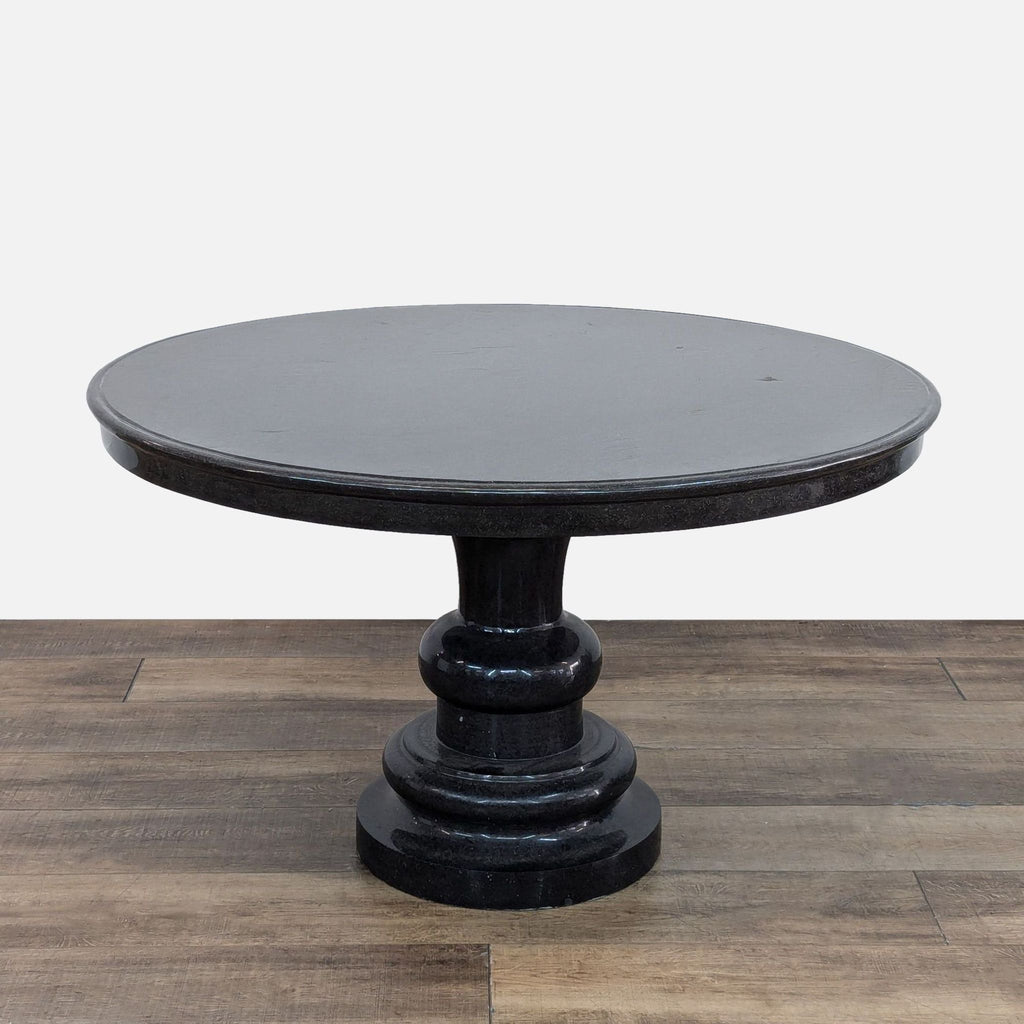 48-inch round black granite table with single pedestal base, shown in category Tables.