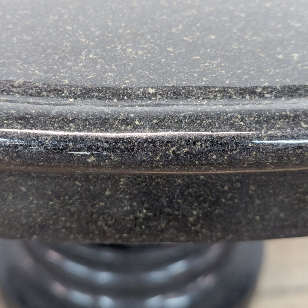 Edge detail of 48” round black granite table by Reperch.