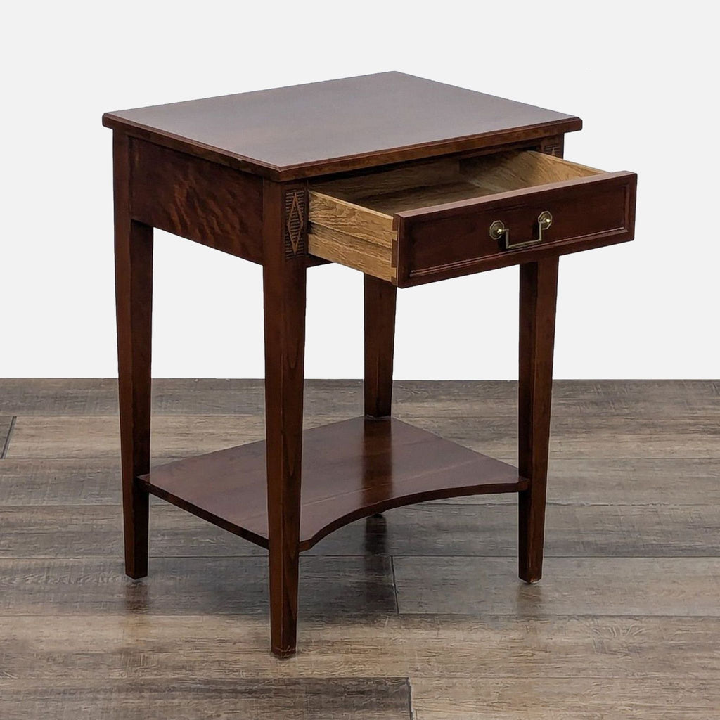 Elegant Stickley end table, featuring an open drawer with brass handle.