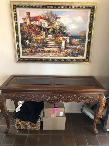 a wooden table with a painting on it 