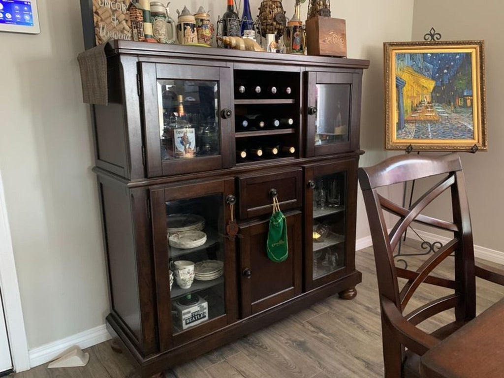 1. Porter Dining Server by Ashley Furniture, a wooden cabinet with drawers and shelves for stylish dining storage.