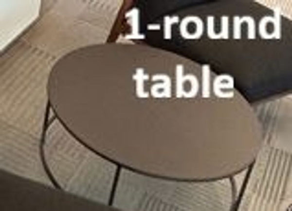 1. Reperch coffee table with a round black top and slim metal frame, shown in a modern room setting.