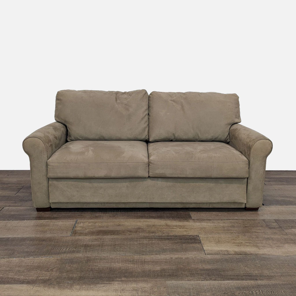 Fabric upholstered sleeper sofa viewed from the front.