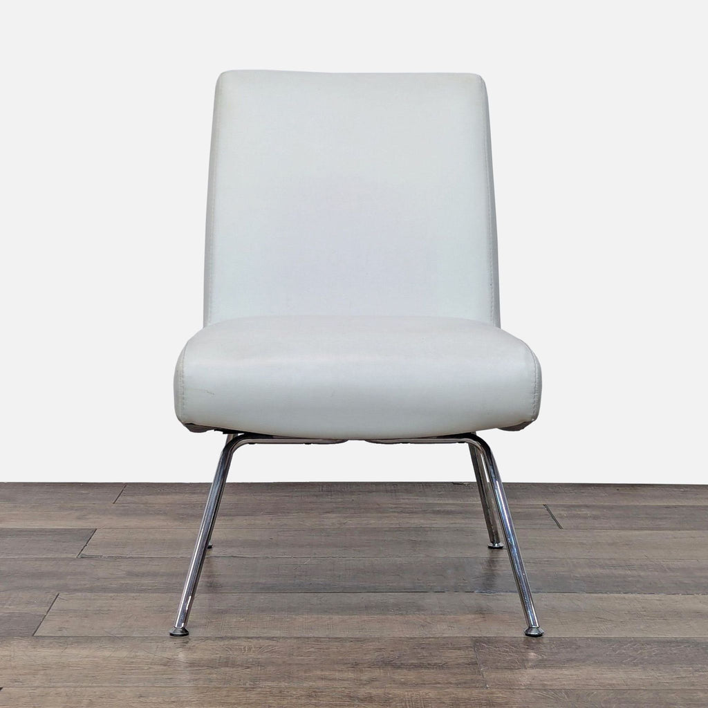 Front view of a white leather chair with chrome legs on wooden floor.
