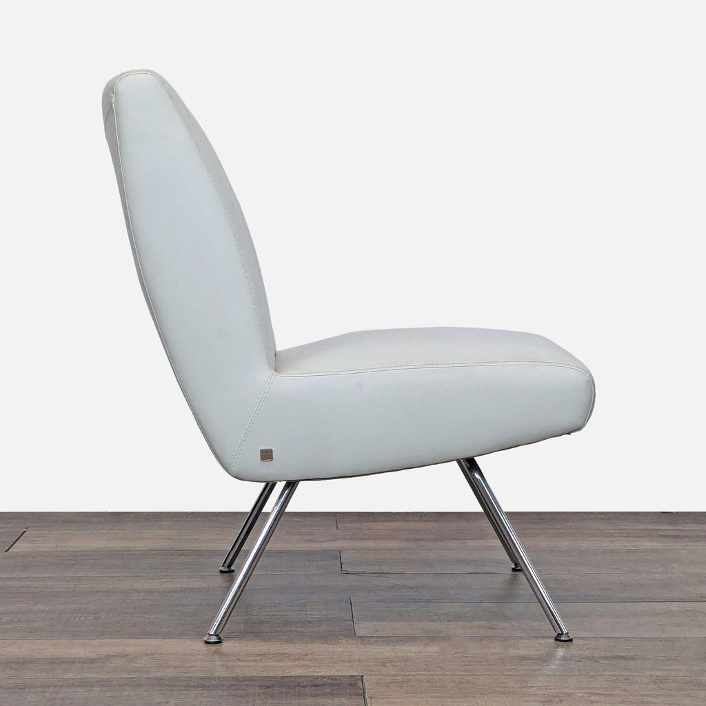 Side view of a sleek white leather chair with slim chrome legs.