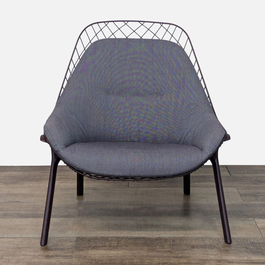 Front view of the Alias lounge chair, with a sleek steel shell and fabric cushion.