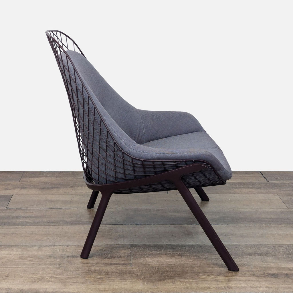 Side angle of the Alias lounge chair, showcasing the aluminum legs and fabric upholstery.