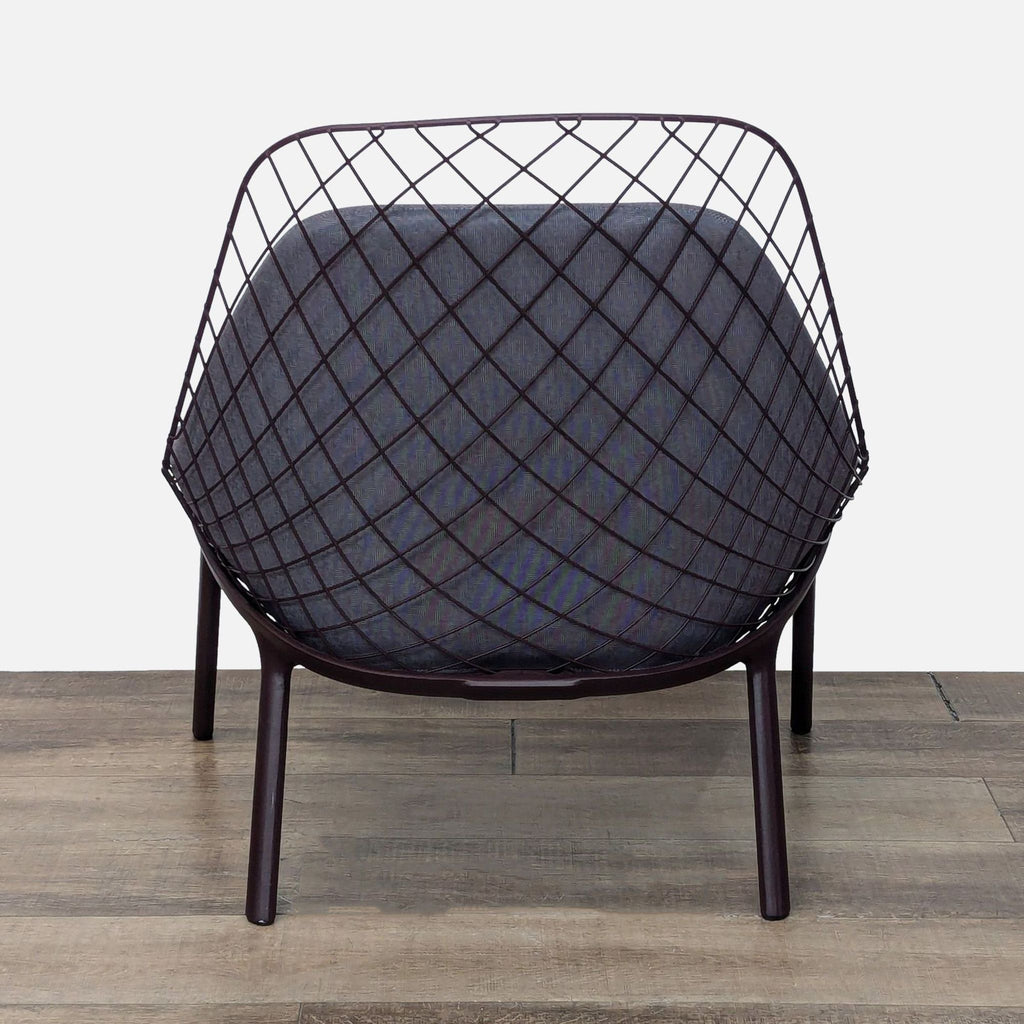 Rear view of the Alias lounge chair, highlighting the lattice-style steel backrest.