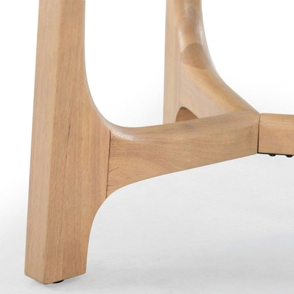 Detail of the V-shaped trestle base on the Safavieh dining table in natural finish.