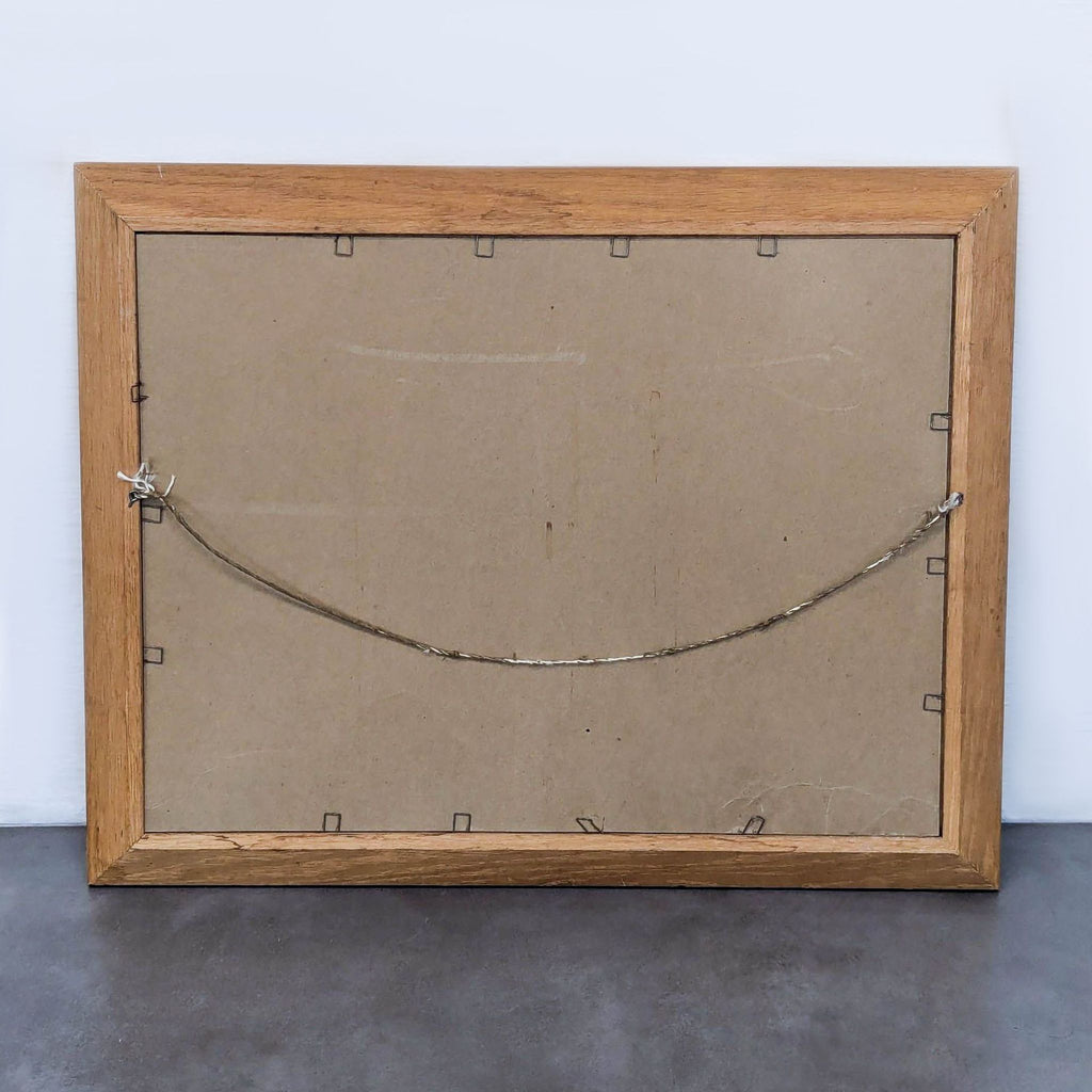 Back view of framed vintage painting with hanging wire.