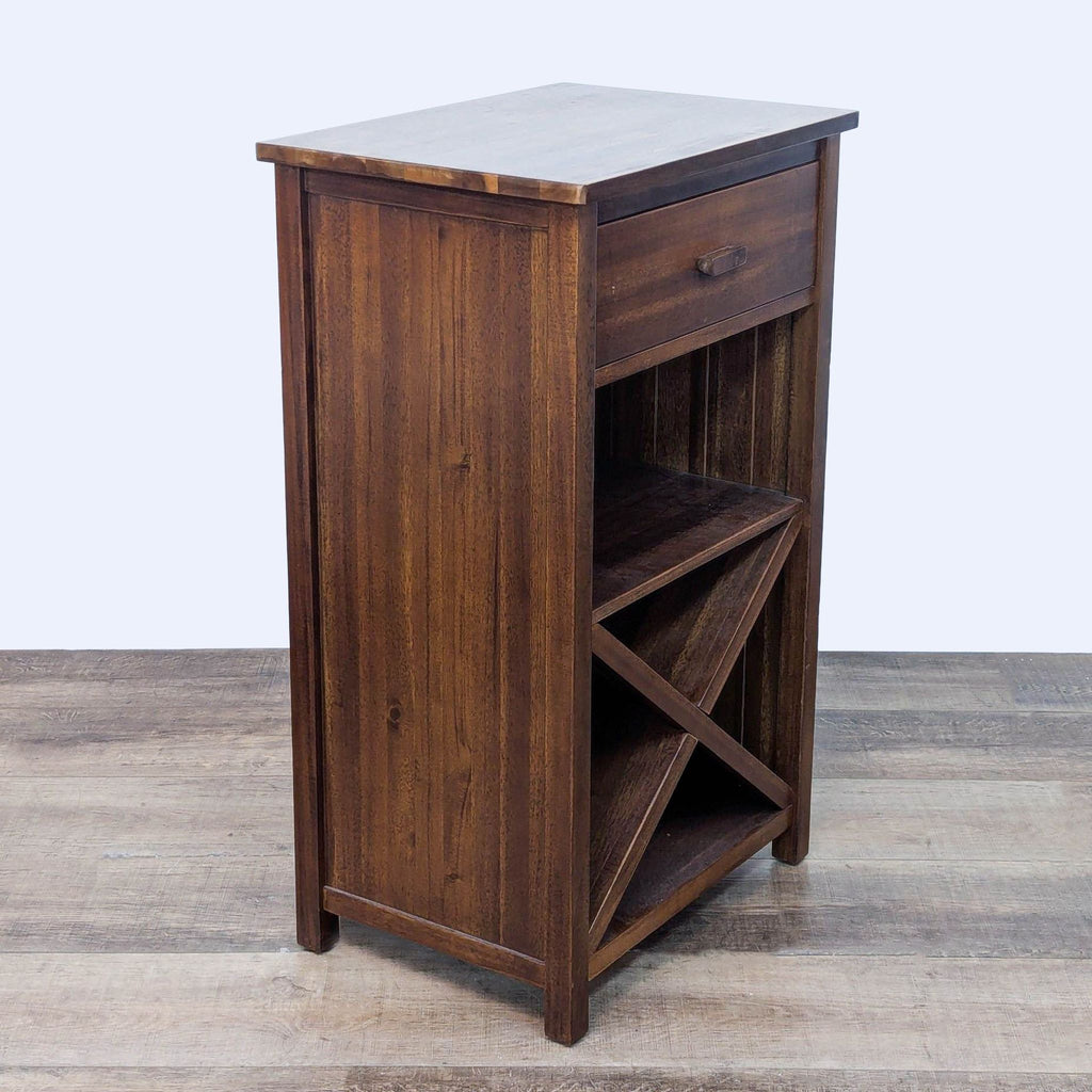 Angled view of wood furniture with closed drawer and open shelf.