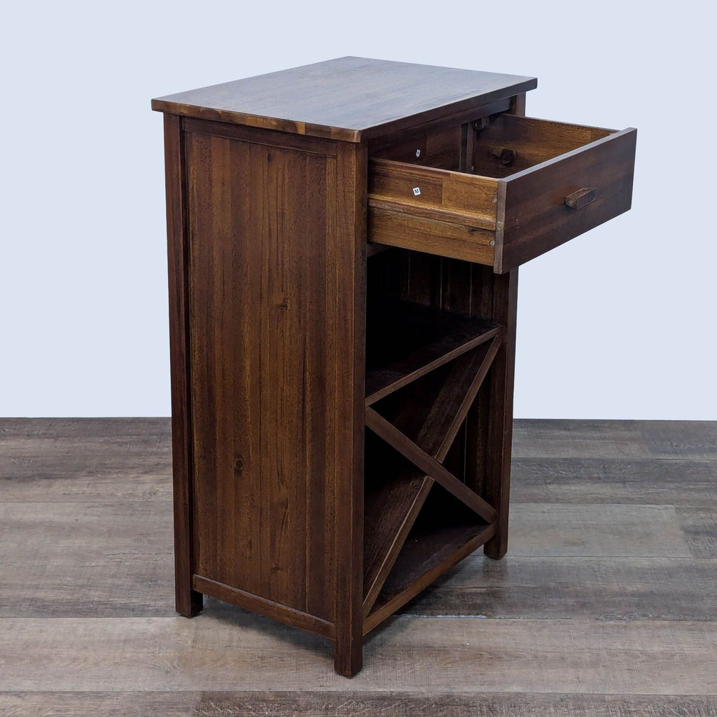Side view of open drawer in wooden furniture with X-shaped shelf.