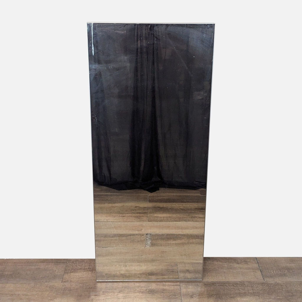 Mirror with a silver-finished aluminum frame reflecting a dark curtain.  