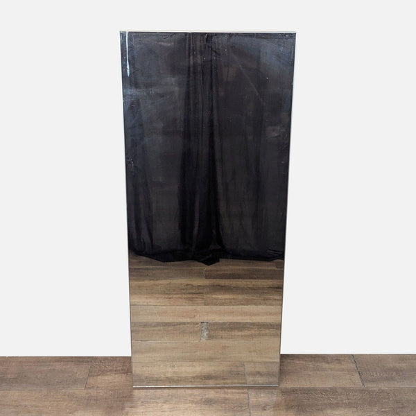 Mirror with a silver-finished aluminum frame reflecting a dark curtain.  