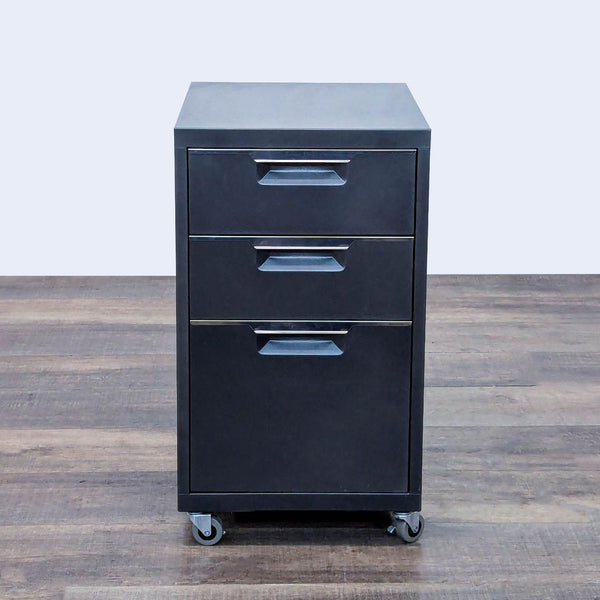 Rolling metal cabinet with three drawers and locking casters.