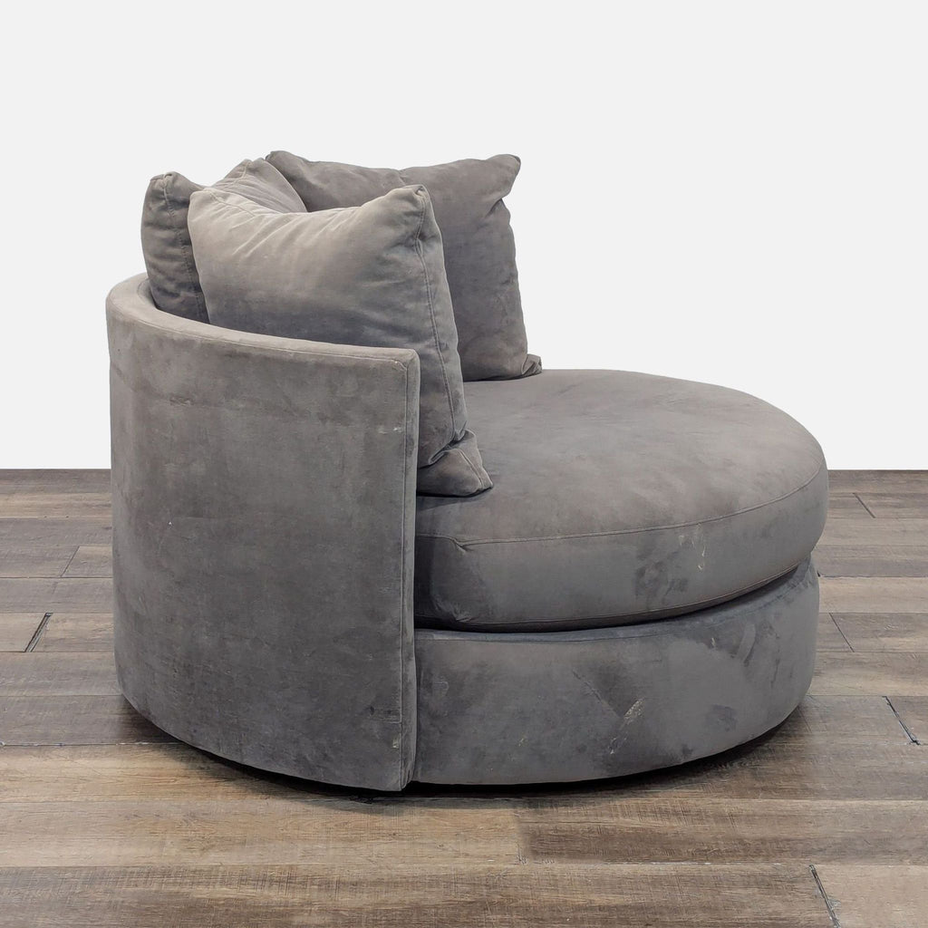 Side view of gray swivel Tillie Grande Chair. Comfy seat with rounded back and throw pillows.